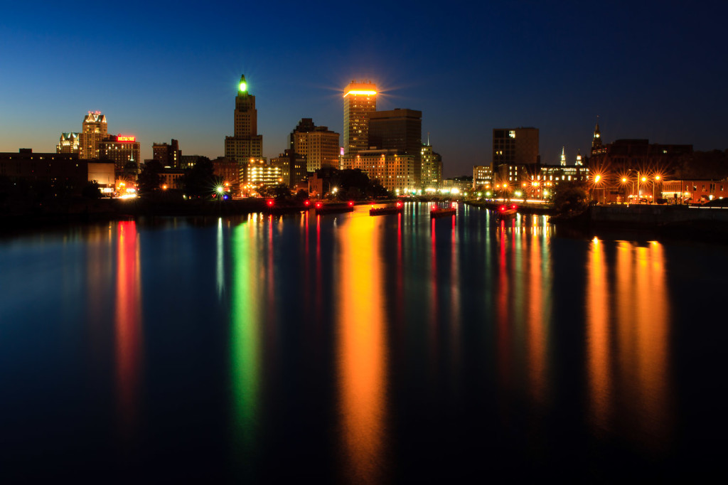 The city lights reflect along the Providence River in this night time photo of the Providence skyline