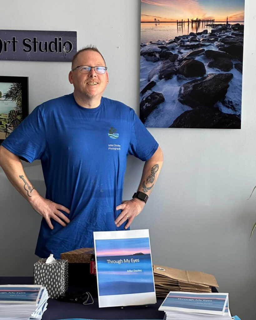 Fine art metal print by Mike Dooley displayed during a book signing event