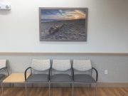 A dramatic landscape canvas by Mike Dooley adds color and calm above the chairs in this East Providence doctors waiting room. A dramatic landscape canvas by Mike Dooley adds color and calm above the chairs in this East Providence doctors waiting room.