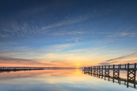 A serene morning over Narragansett Bay, captured near the Rhode Island Yacht Club, with soft light dancing on the water.