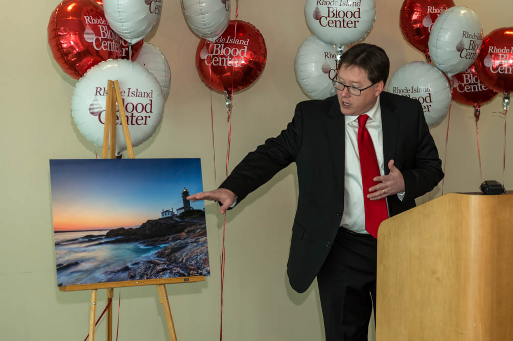 Rhode Island photographer Mike Dooley talks about his photograph "The Lighthouse" at the RI Blood Center Press Conference