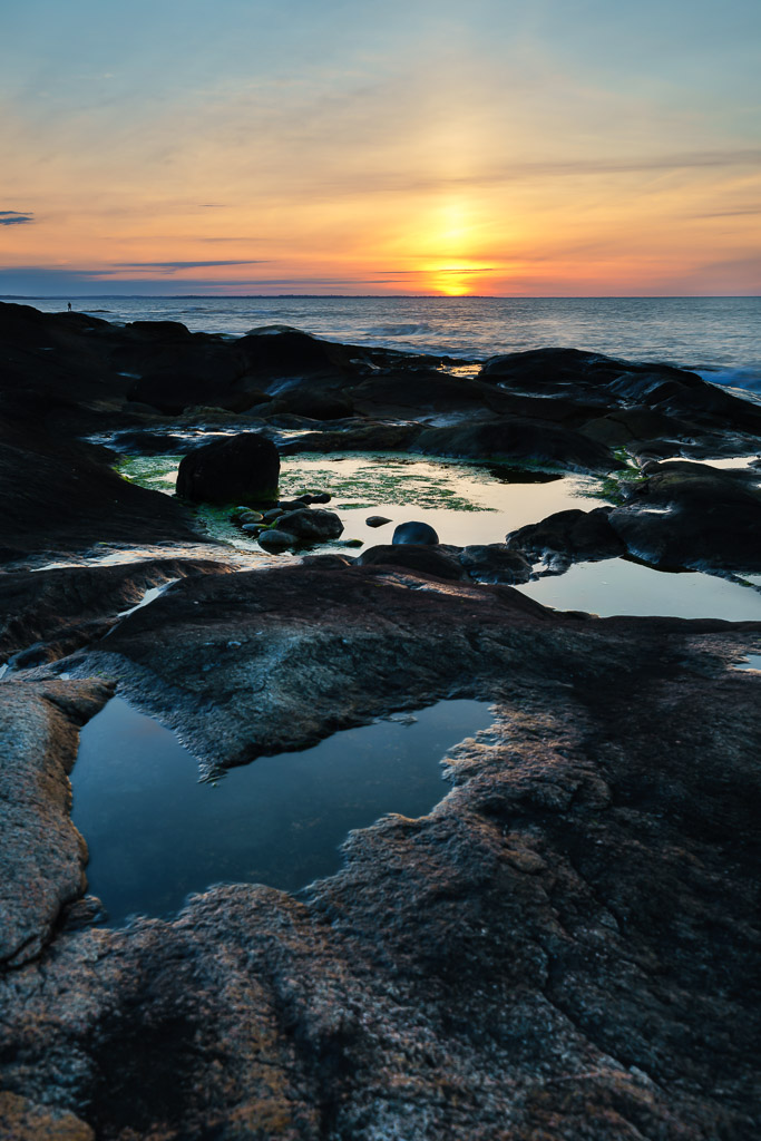 Sunrise on the Rocks – Heart-shaped depression in rocks at the beach, morning sunlight reflecting off tide pools, photographed by Mike Dooley.