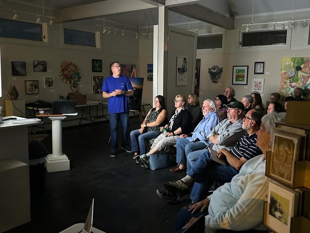 Mike Dooley presenting The Art of the Seascape to the Wickford Art Association, engaging the audience with coastal photography stories and techniques.”