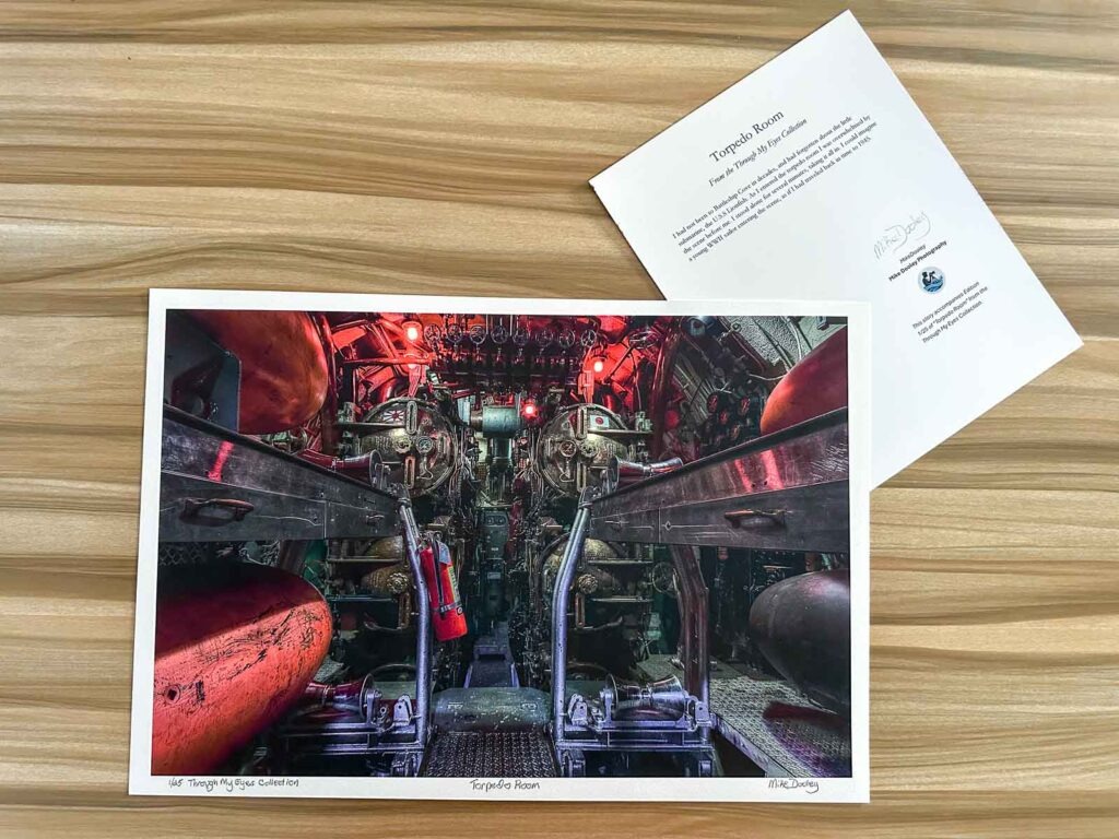 Archival print of the Torpedo Rooms, showing dim industrial textures and layered shadows; part of the Signature series, signed and numbered with accompanying story card.