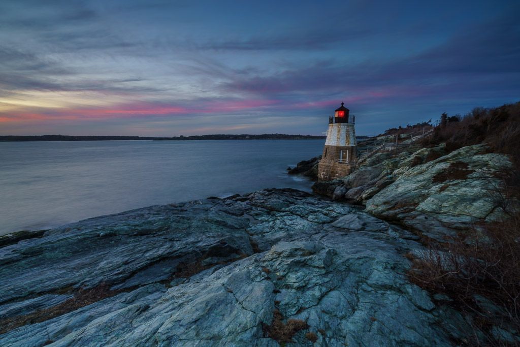 Castle Hill Lighthouse perched on rugged cliffs with waves crashing below, Newport, Rhode Island