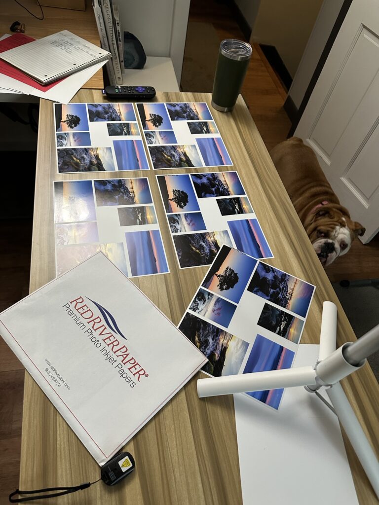 A stack of printed photographs in various sizes on different paper types.