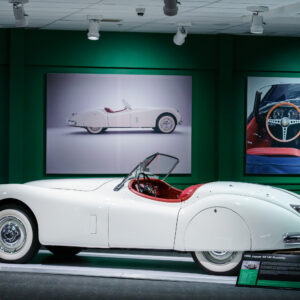 Side view of a white 1956 Jaguar XK140 Roadster convertible at the Newport Car Museum, photographed as a fine art print by Mike Dooley.