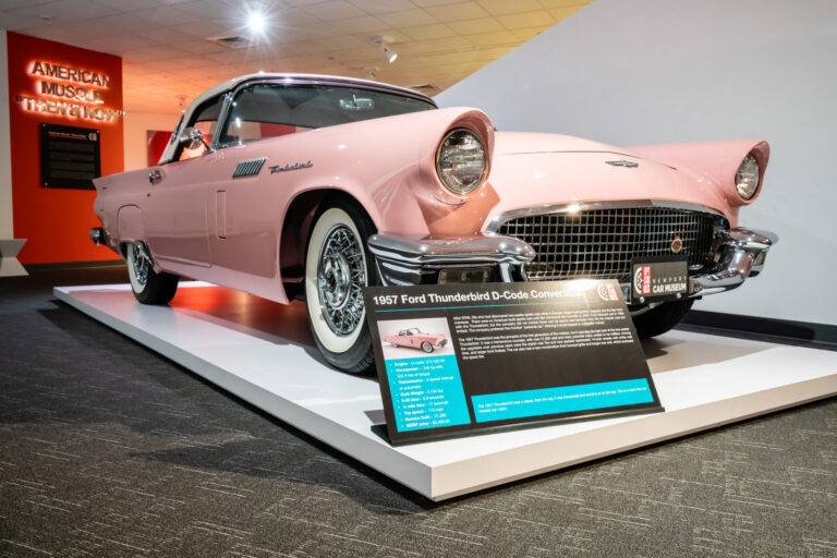 1957 Ford Thunderbird D-Code convertible in soft pink with white top at the Newport Car Museum