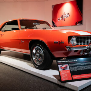 1969 Chevrolet Camaro Z28 in bold orange with white racing stripes at the Newport Car Museum, photographed as a fine art print by Mike Dooley.