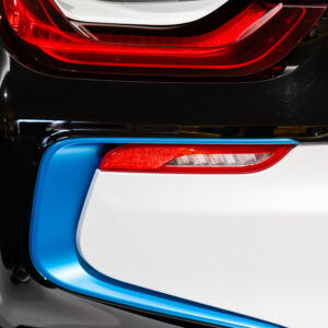 Close-up of the taillights of an electric BMW at the Newport Car Museum, photographed as a fine art print by Mike Dooley.