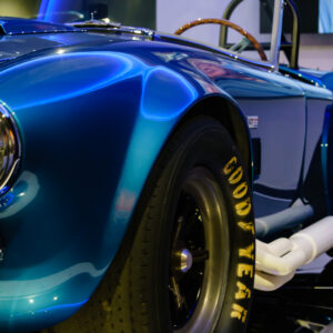 Side view down the body of the Electric Blue Shelby Cobra at the Newport Car Museum, photographed as a fine art print by Mike Dooley.