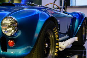 Side view down the body of the Electric Blue Shelby Cobra at the Newport Car Museum, photographed as a fine art print by Mike Dooley.