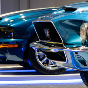 Front views of three Mustang cars from different generations at the Newport Car Museum, photographed as a fine art print by Mike Dooley.
