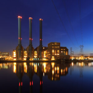 Manchester Street Power Station illuminated at night along the Providence River in Rhode Island.