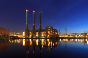 Manchester Street Power Station illuminated at night along the Providence River in Rhode Island.