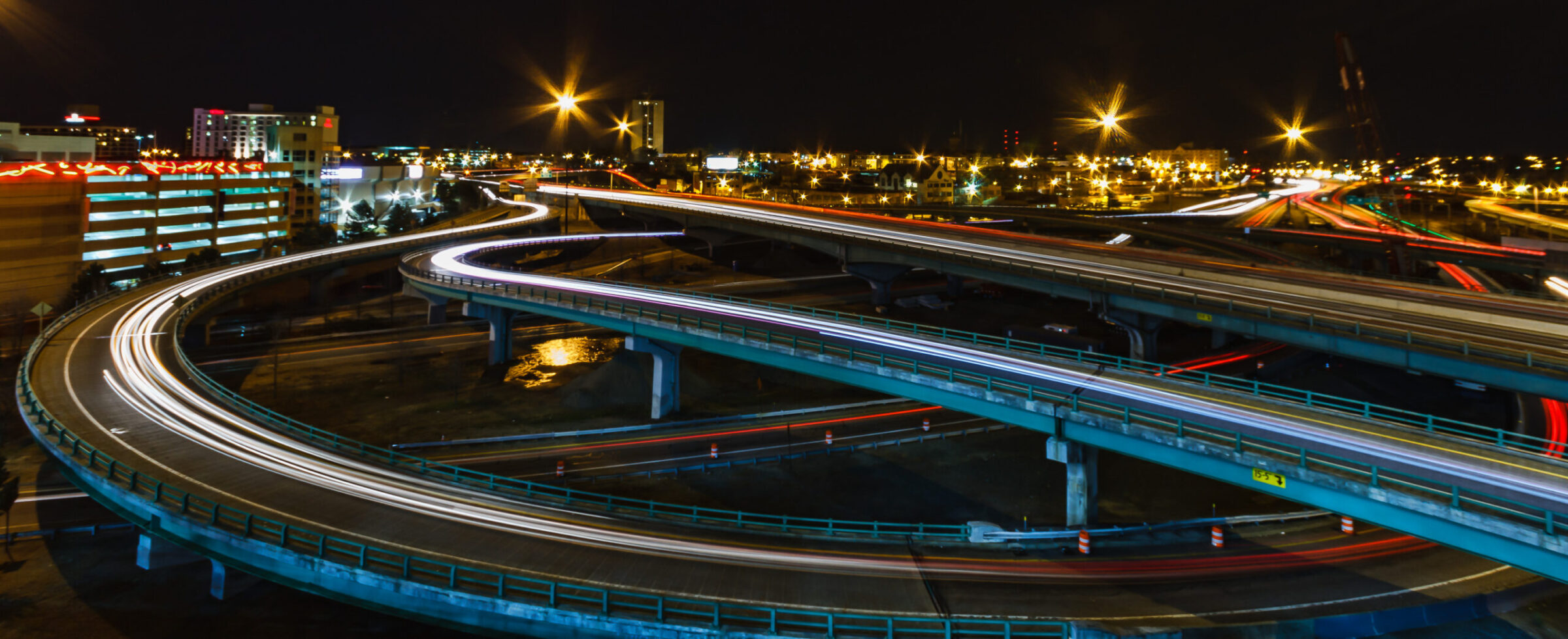 Aerial view of Providence highways at night, glowing lights weaving through the city