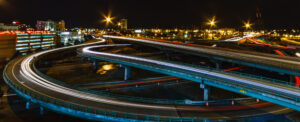Aerial view of Providence highways at night, glowing lights weaving through the city