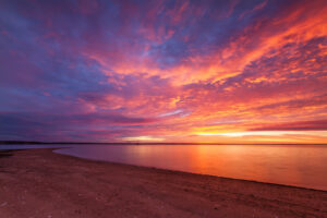 Sunrise at Conimicut Point in Warwick, Rhode Island, with vivid red skies, photographed by Mike Dooley.