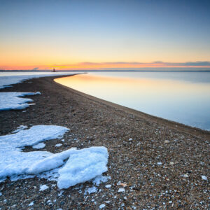 Sunrise over the snow-covered beach at Conimicut Point Park in Warwick, Rhode Island, photographed by Mike Dooley.