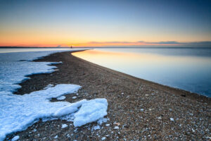 Sunrise over the snow-covered beach at Conimicut Point Park in Warwick, Rhode Island, photographed by Mike Dooley.