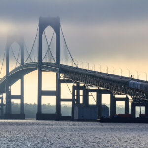 Newport Bridge partially obscured by fog on a summer evening, photographed by Mike Dooley.