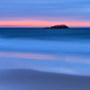 Sunrise at Narragansett Beach, Rhode Island, with Whale Rock—the remaining lighthouse foundation—photographed by Mike Dooley.