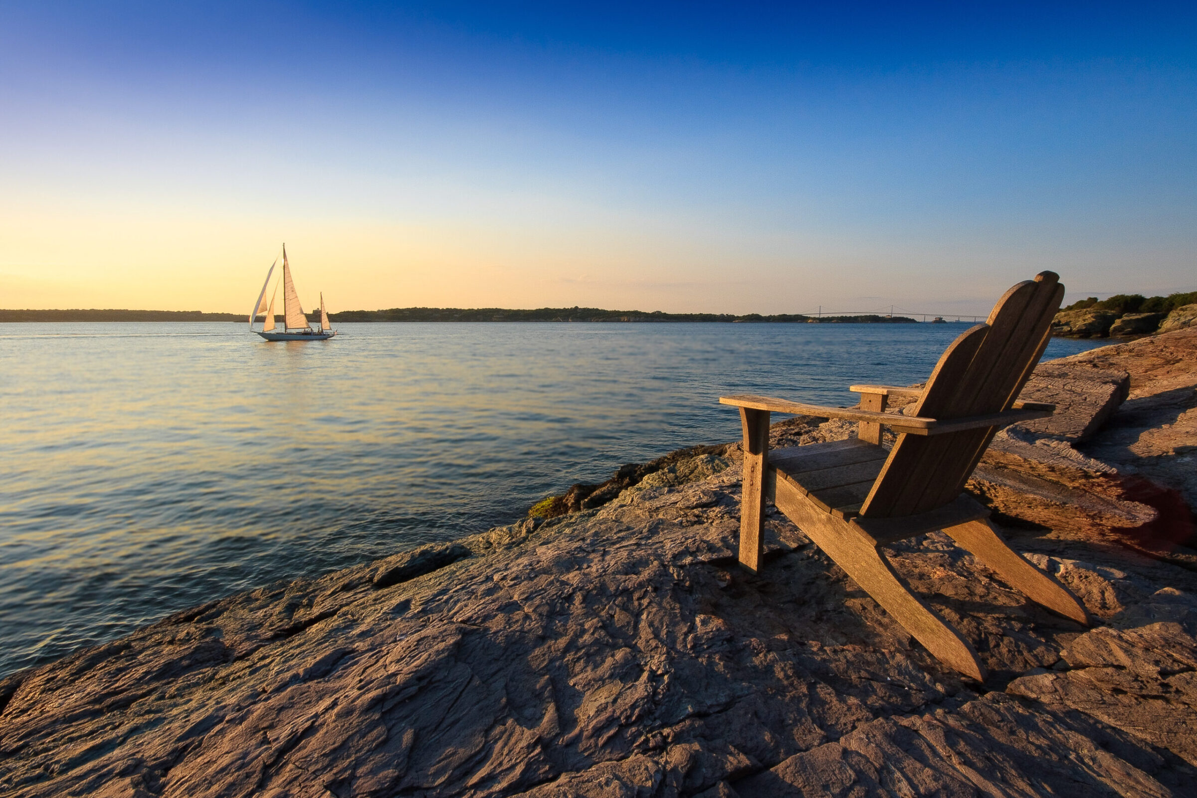 Sailboat at sunset in Newport Harbor, Rhode Island, photographed by Mike Dooley