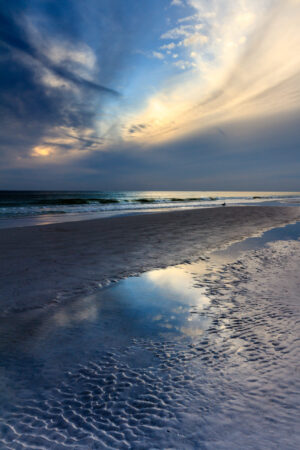 Sunset at Siesta Key Beach, Florida, with colorful sky and calm waves, photographed by Mike Dooley.