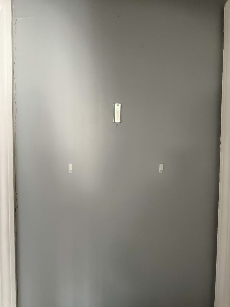 3M Command picture hanger attached to a wall ready to hold framed artwork