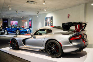 Silver Dodge Viper with red and black racing stripes at the Newport Car Museum
