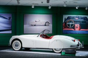 Side view of a white 1956 Jaguar XK140 Roadster convertible at the Newport Car Museum