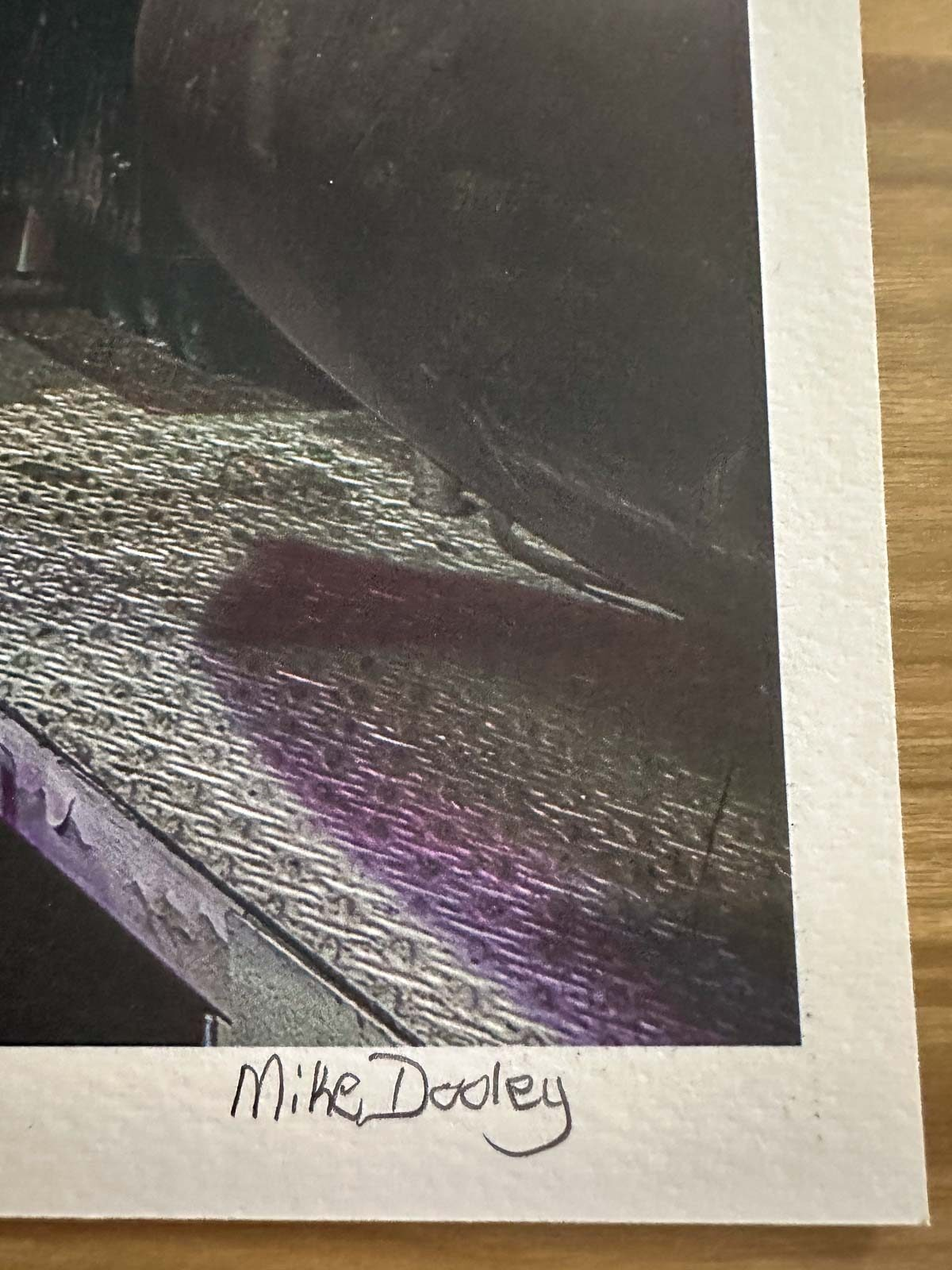 Close-up of the signature and edition number on a limited edition Signature Series print by Mike Dooley.