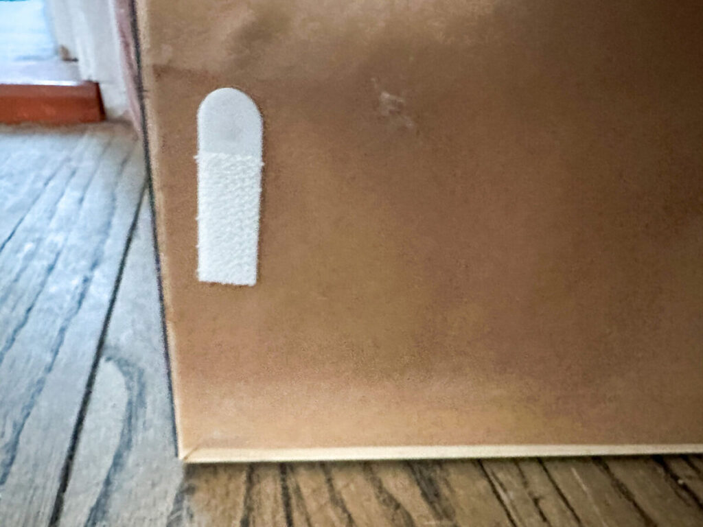 3M Command picture hanging strips used to keep framed artwork level on the wall