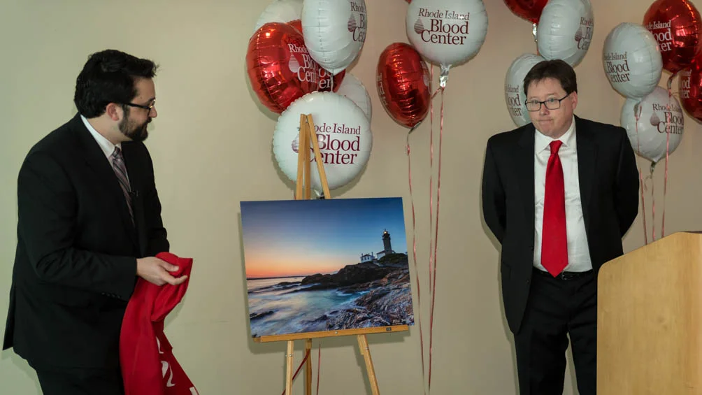 The Lighthouse print revealed on an easel at the 2015 RI Blood Center Seasons Pass press conference, red cover just pulled away