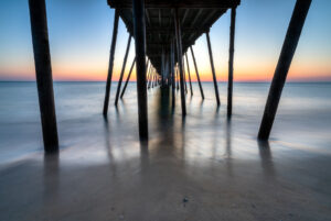 Sunrise light through the pilings of a fishing pier on North Carolina's Outer Banks