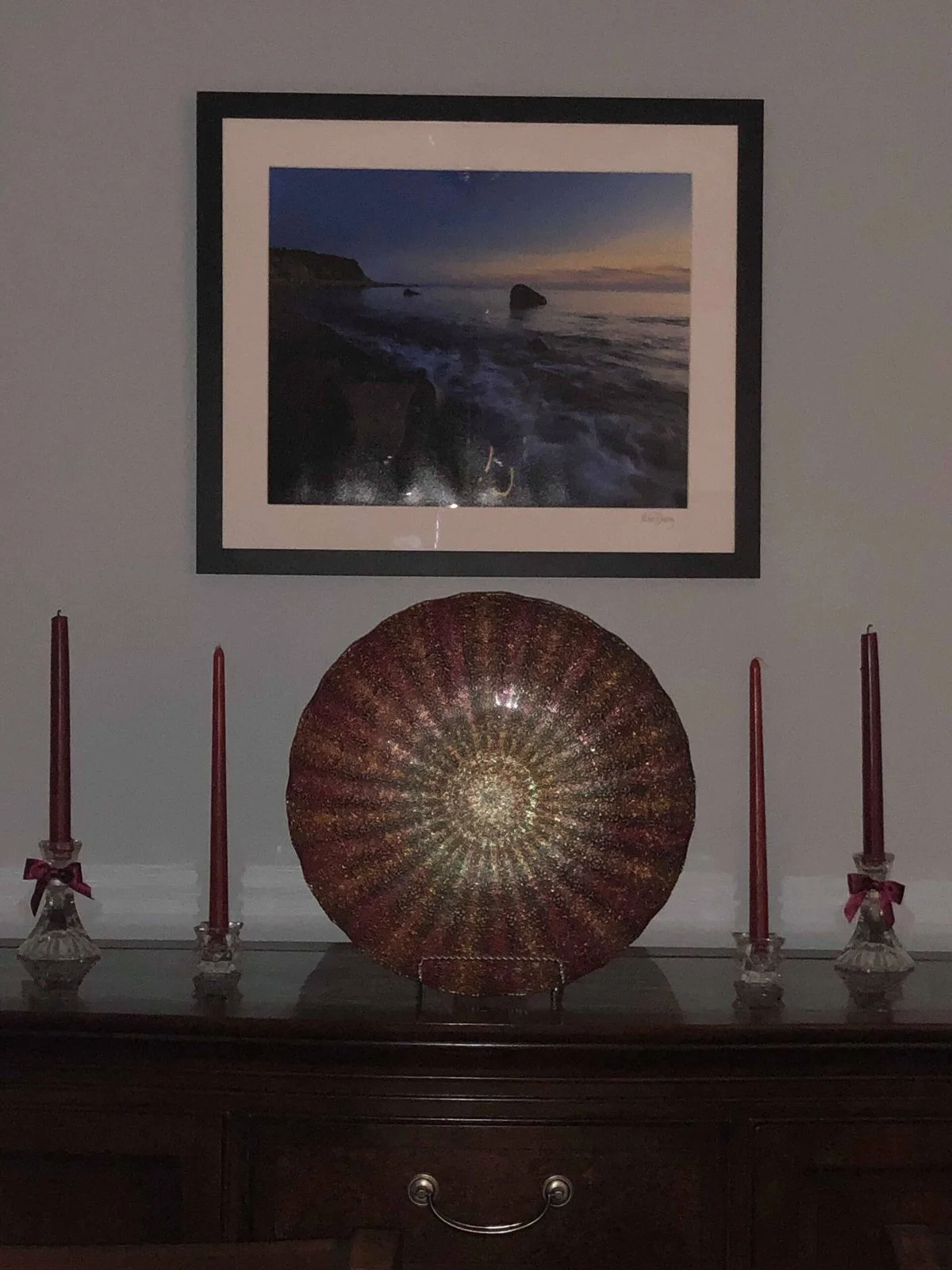Framed Mike Dooley print of Block Island waves hanging above a sideboard in a client's home.