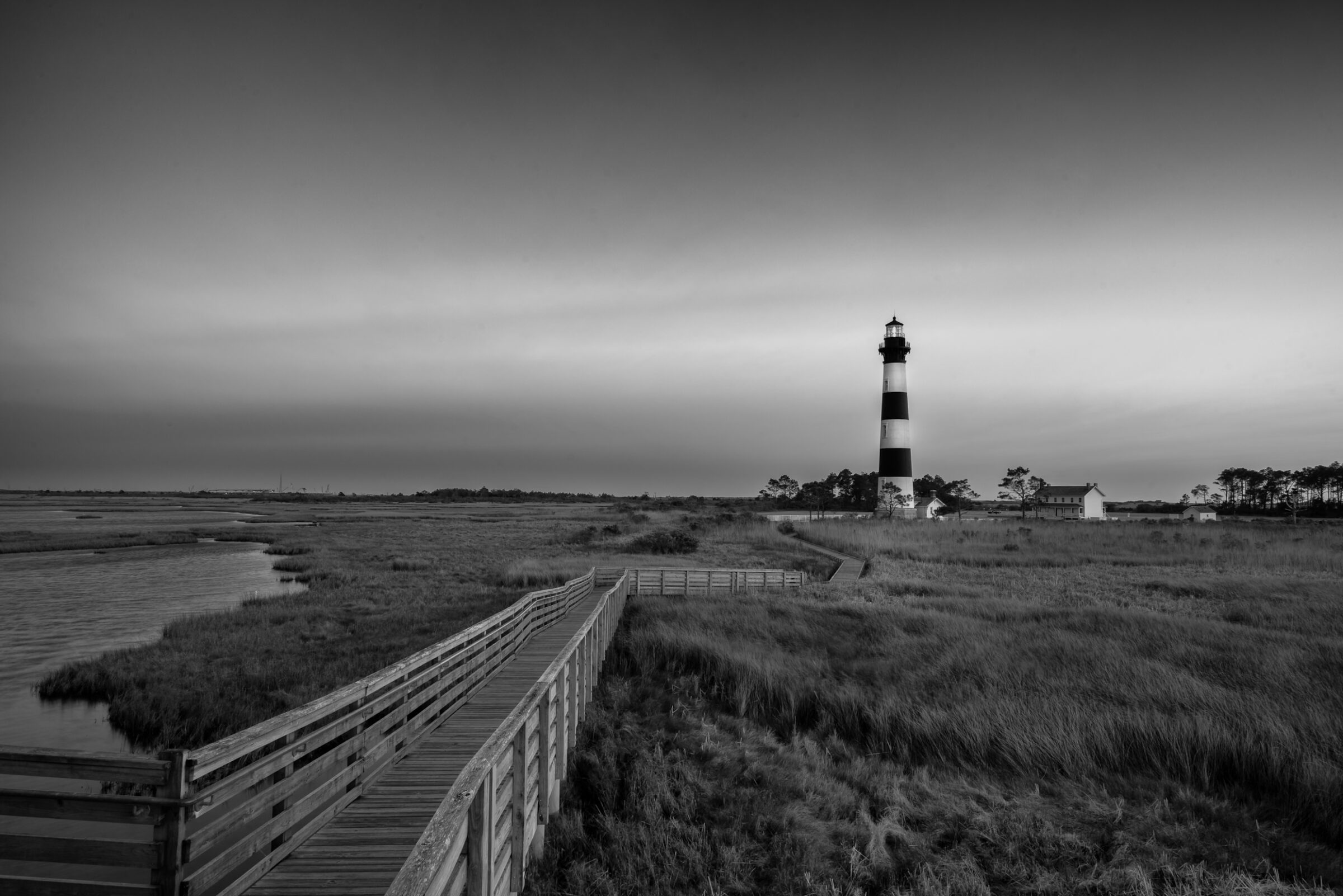 Bodie Island Lighthouse at sunset across the marsh from the boardwalk, Outer Banks, North Carolina, black and white photograph by Mike Dooley