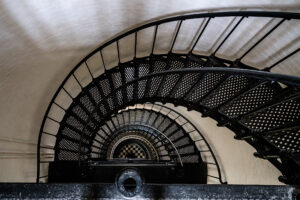 Looking down a lighthouse spiral staircase to the checkered floor below, Outer Banks, North Carolina