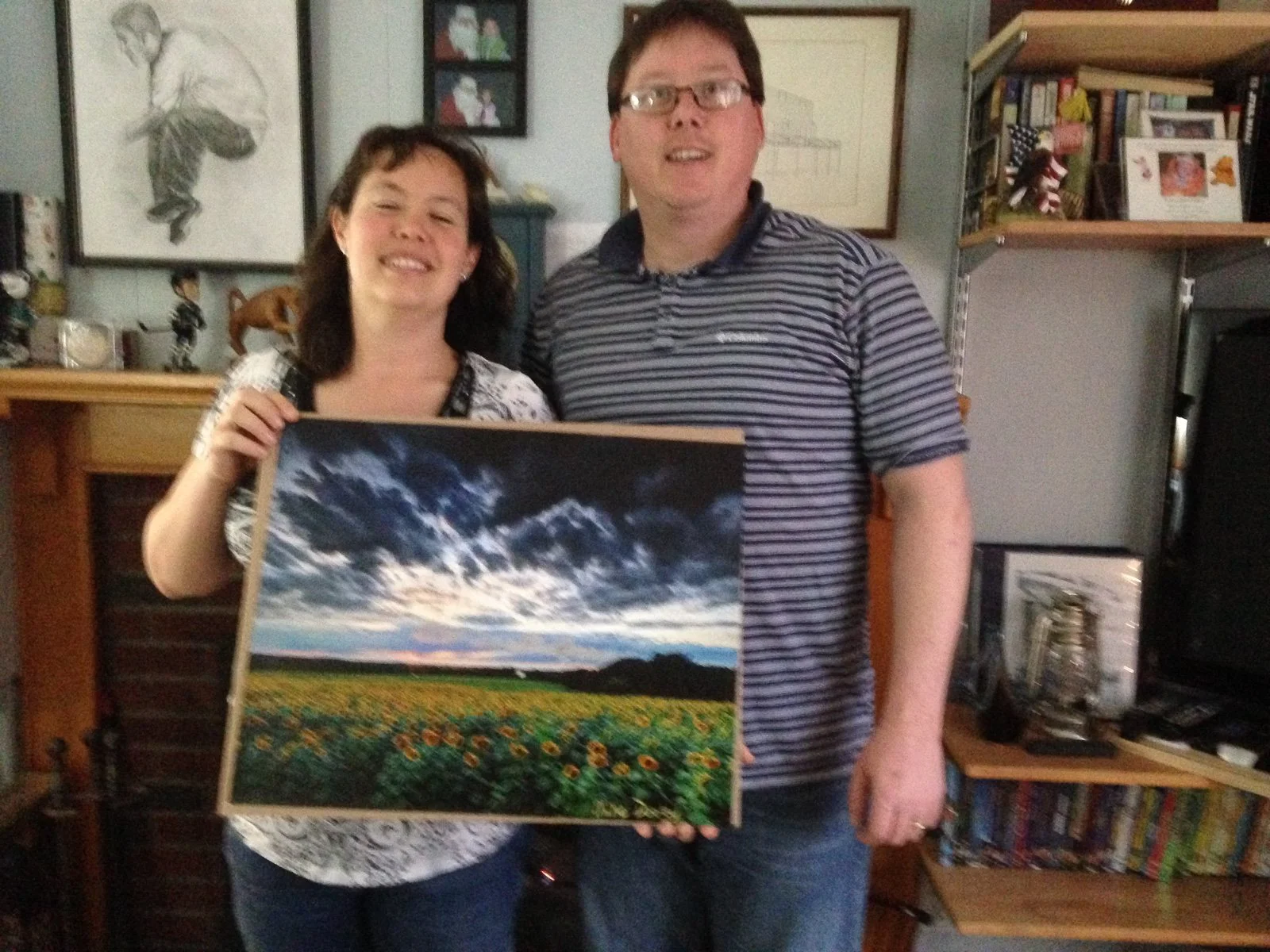 Mike Dooley and a smiling customer holding her newly signed sunflower print.