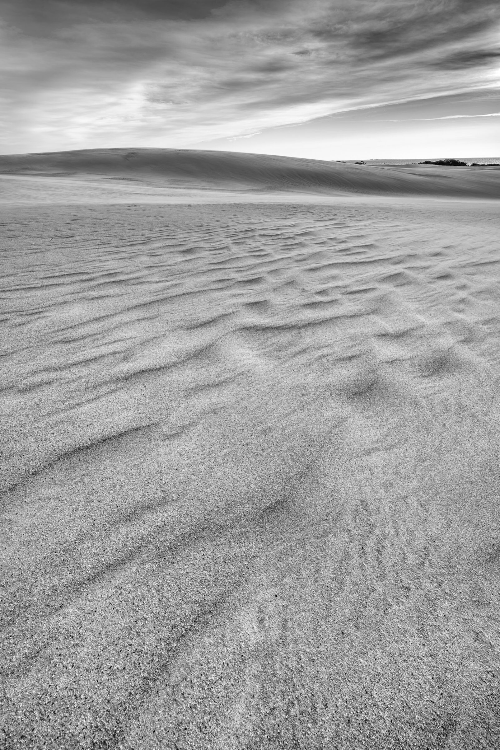 Wind-rippled sand and clouds at sunset, Jockey's Ridge State Park, Outer Banks, North Carolina, black and white fine art photograph by Mike Dooley