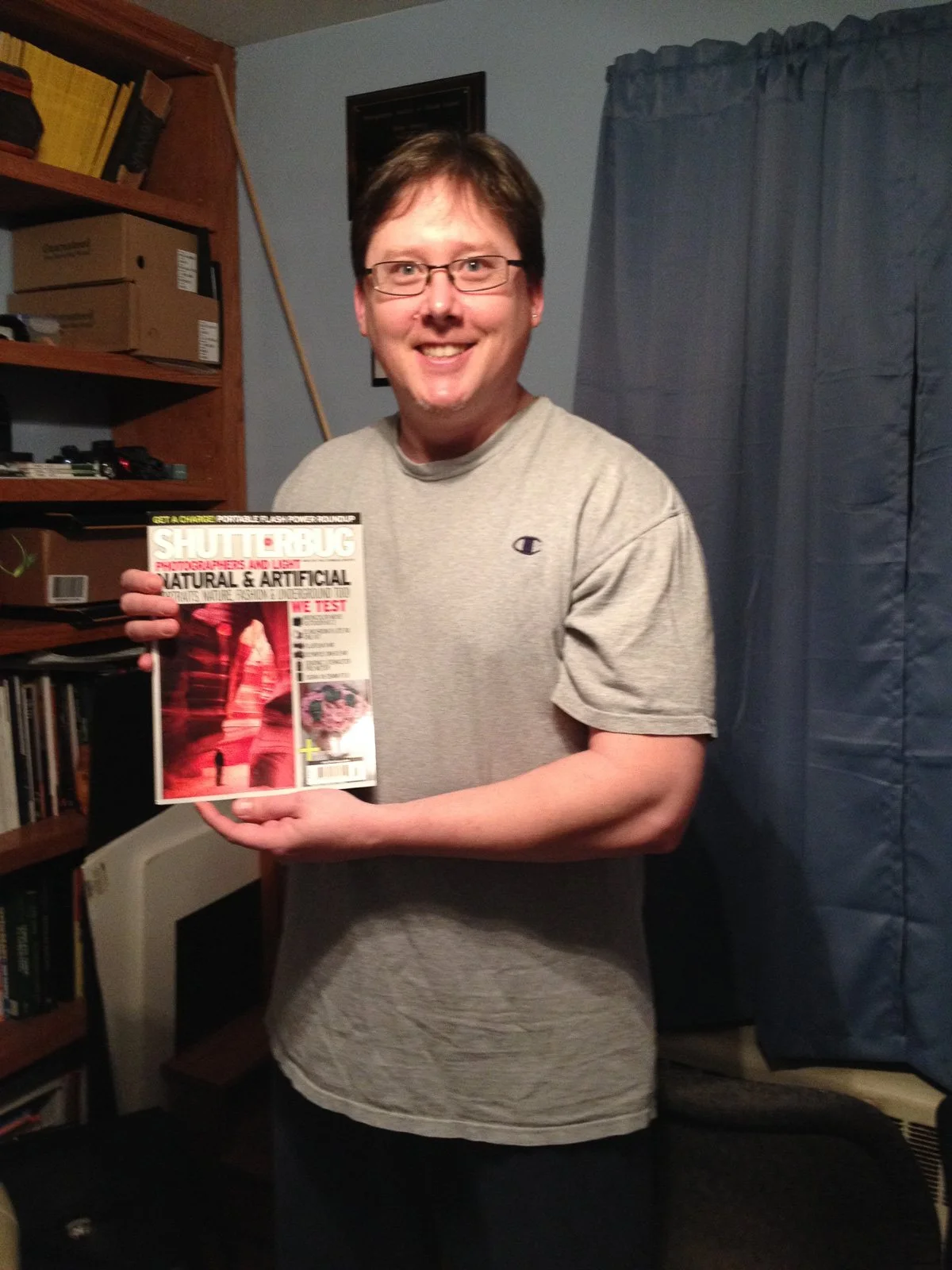 Mike Dooley holding the issue of Shutterbug Magazine that featured his photography website.