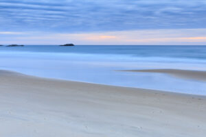 Long exposure of soft blue surf and pale sand at sunrise, Narragansett Beach, Rhode Island, by Mike Dooley
