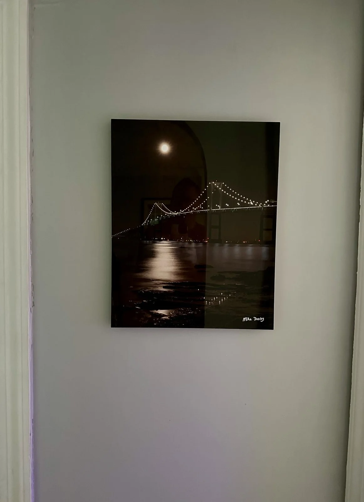 Metal print by Mike Dooley of the Newport Bridge under a full moon, hanging on a wall.