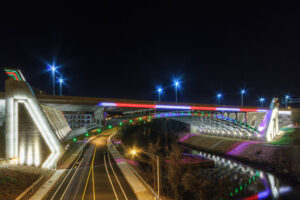 The Pawtucket River Bridge lit in color at night with light trails on the road below, Pawtucket, Rhode Island, by Mike Dooley