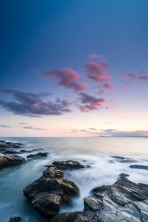 Water moving around the rocks under pink clouds at sunset, Beavertail State Park, Jamestown, Rhode Island, by Mike Dooley