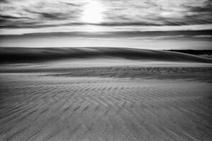 Black and white photograph of wind-rippled sand dunes at sunset, Jockey's Ridge State Park, Outer Banks, North Carolina, by Mike Dooley