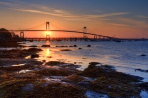 Sunrise aligning through the uprights of the Newport Bridge, seen from Jamestown